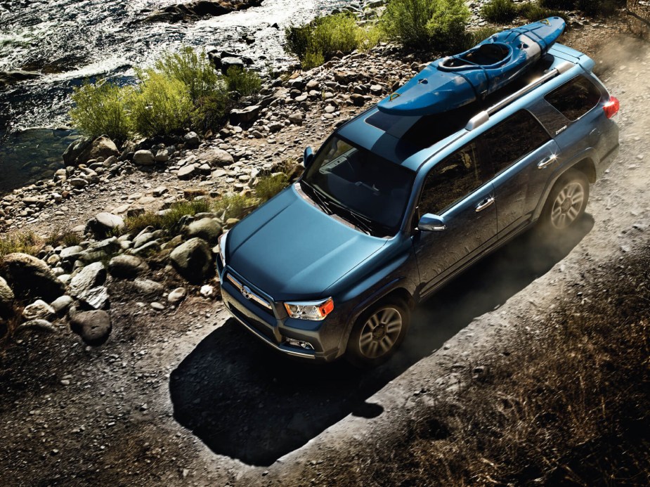 A 2013 Toyota 4Runner traverses an off-road trail, top-down view. 