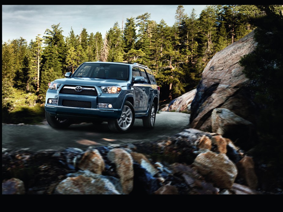 2013 Toyota 4Runner with rocks in foreground and trees in background. 