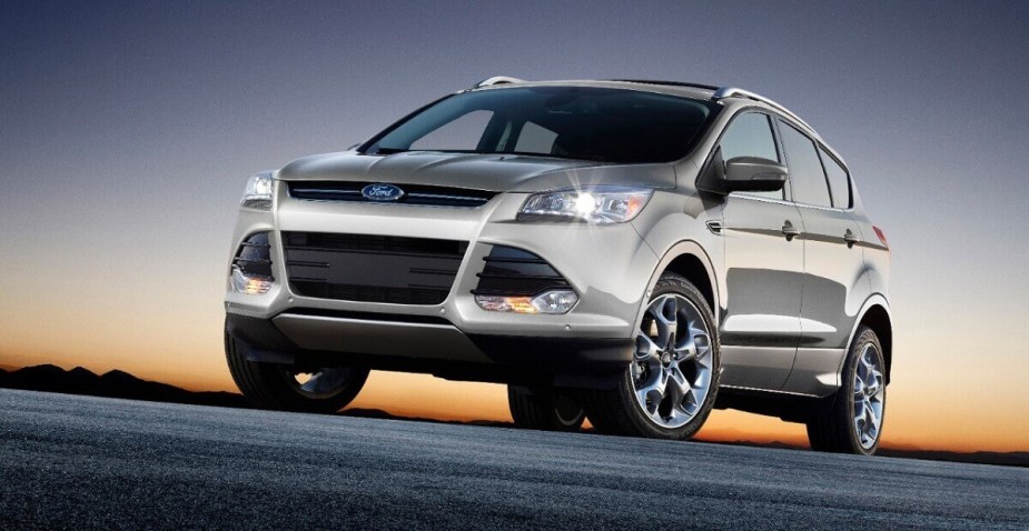 A silver 2014 Ford Escape shows off its LED lights and front-end styling. 