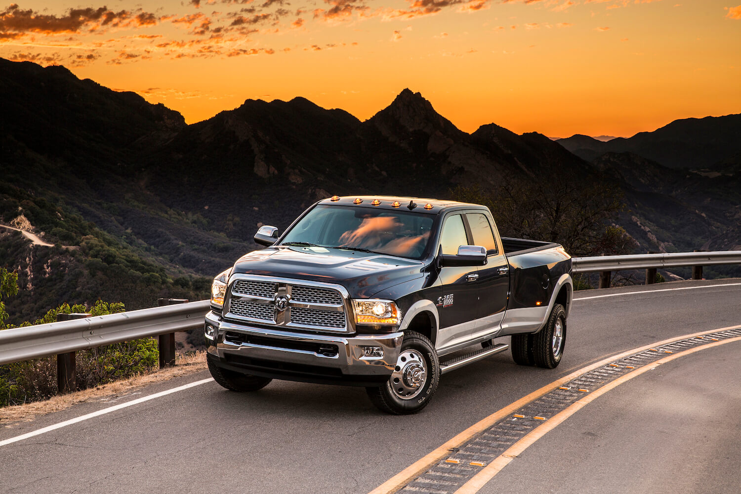 Advertising photo of the final manual transmission stick shift pickup truck, the 2018 Cummins-powered Ram 3500, parked in front of a sun set.