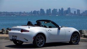 A white 2023 Mazda MX-5 Miata shows off its non-RF convertible top.