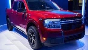 A red 2022 Ford Maverick parked indoors.