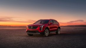 A red 2023 Cadillac XT4 at sunset