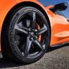 An orange 2023 Chevrolet Corvette Z06 on a blacktop surface.