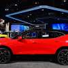 2023 Red Chevrolet Blazer at an auto show from the side.