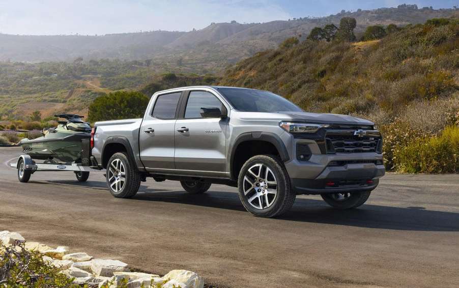 The 2023 Chevy Colorado towing a jetski down the road