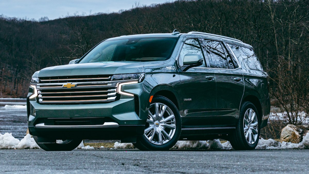 Green 2023 Chevy Tahoe parked with snow in the background