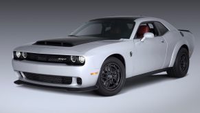 A silver and black 2023 Dodge Challenger SRT Demon 170 poses at a photo shoot.