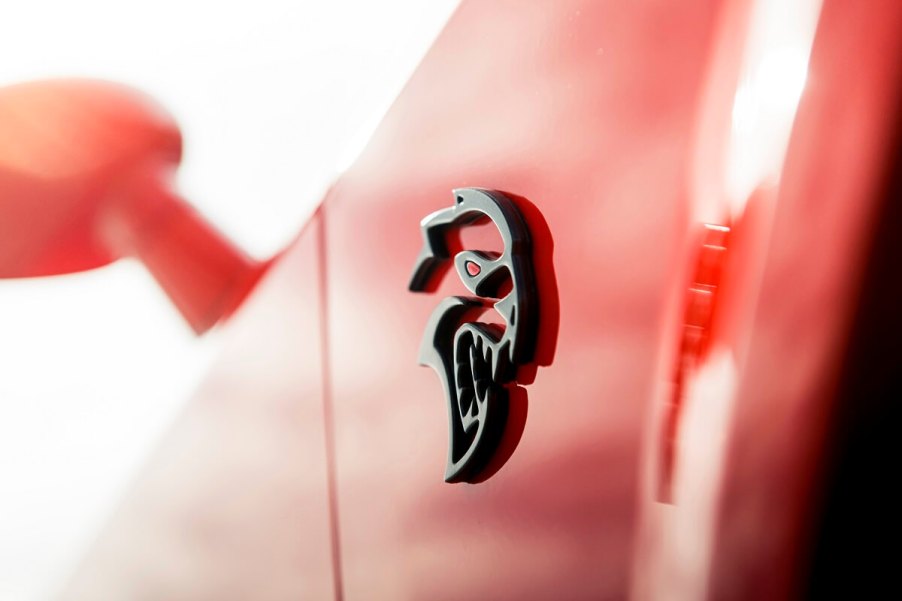 A new, bright orange Dodge Hellcat Redeye shows off its unique badge.