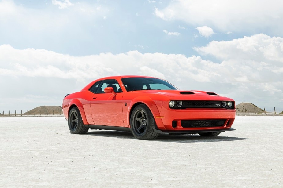 An orange 2023 Dodge Challenger SRT Hellcat shows off its muscle car proportions and fascia in the desert.