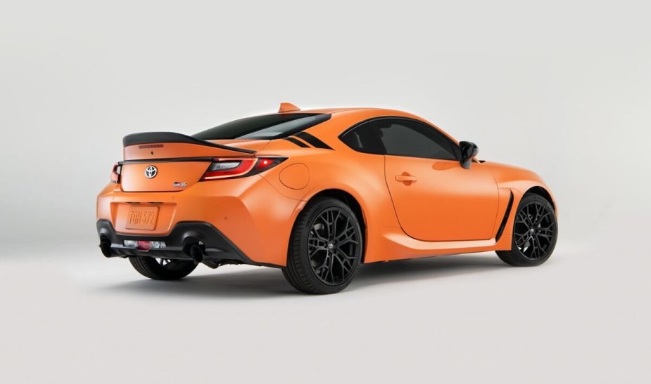 The 2023 Toyota GR86 shows off its sports car platform with bright orange paintwork. 