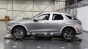 A silver 2023 Genesis G80 parked indoors.