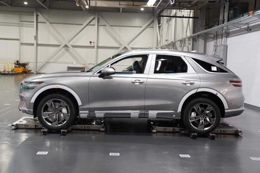 A silver 2023 Genesis G80 parked indoors.