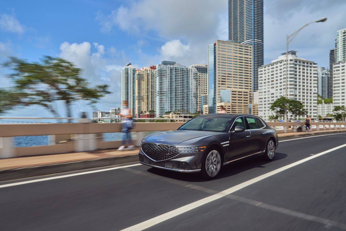 A 2023 Genesis G90 driving down the road.