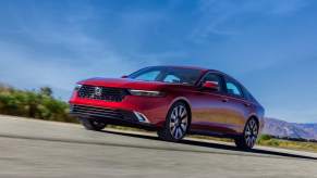 A red 2023 Honda Accord Touring parked outdoors.