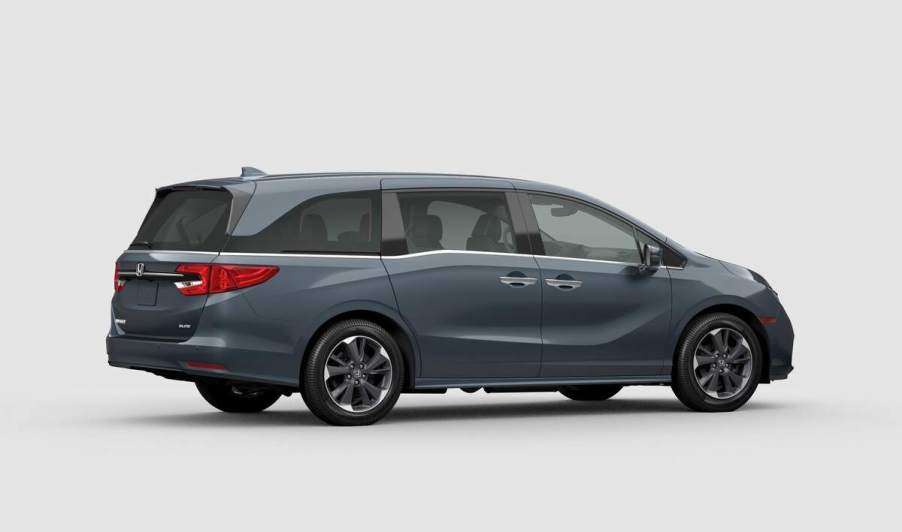 A light blue 2023 Honda Odyssey in a whit room.