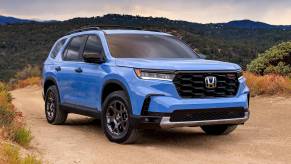 The 2023 Honda Pilot off-roading on a dirt trail