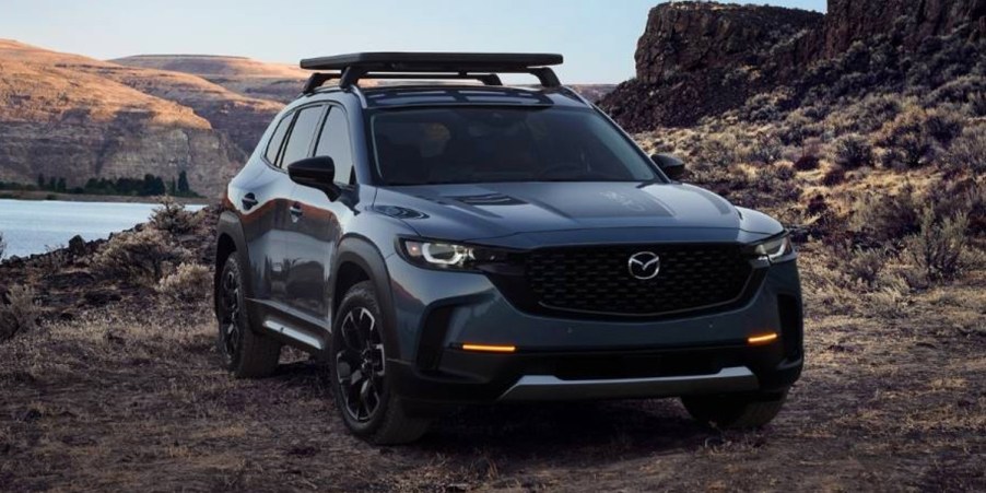 A blue 2023 Mazda CX-50 small SUV is parked off-road.