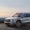 A gray 2023 Mercedes-Benz GLB-Class compact luxury SUV model parked overlooking a city of night lights