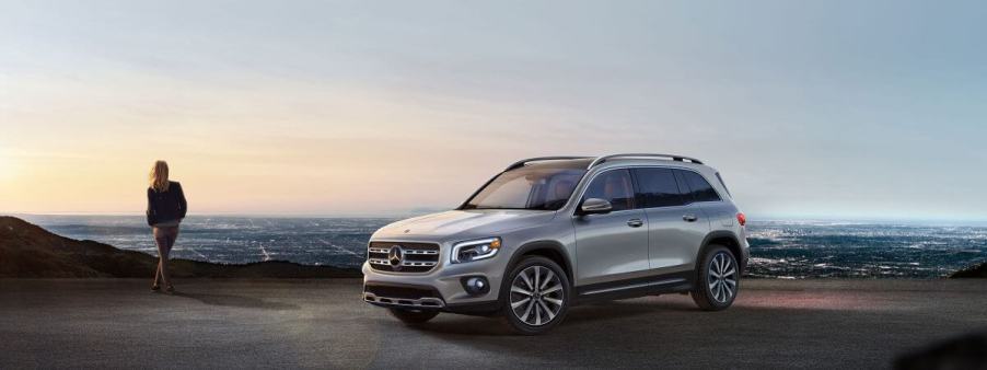 A gray 2023 Mercedes-Benz GLB-Class compact luxury SUV model parked overlooking a city of night lights