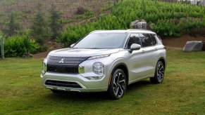 A white 2023 Mitsubishi Outlander small SUV is parked.