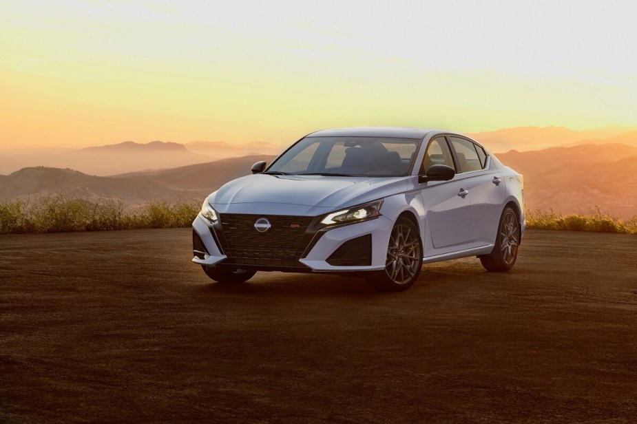 A new white 2023 Nissan Altima shows off its refreshed car styling and LED lights.