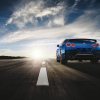 A bright blue 2023 Nissan GT-R shows off its rear-end styling on a road.