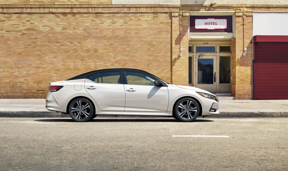 A white 2023 Nissan Sentra S sits in front of a building.