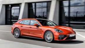 An orange Porsche Panamera Turbo S from the best luxury car brand of 2023