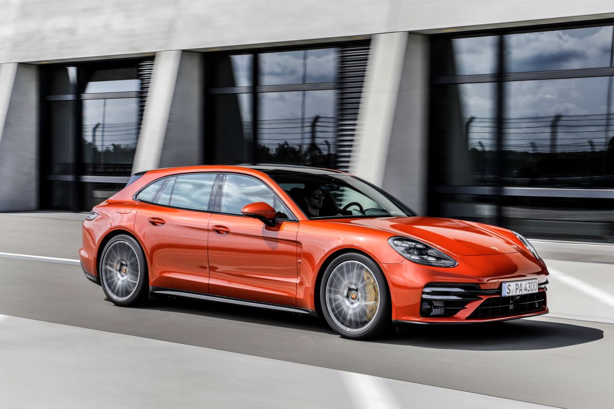 An orange 2023 Porsche Panamera Turbo S driving