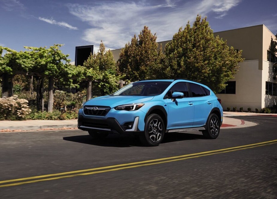 A safe, small 2023 Subaru Crosstrek shows off liftback car proportions with bright blue paintwork. 