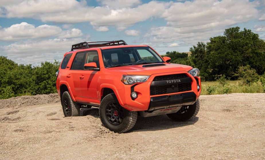 An orange Toyota 4Runner 2023 off road. 