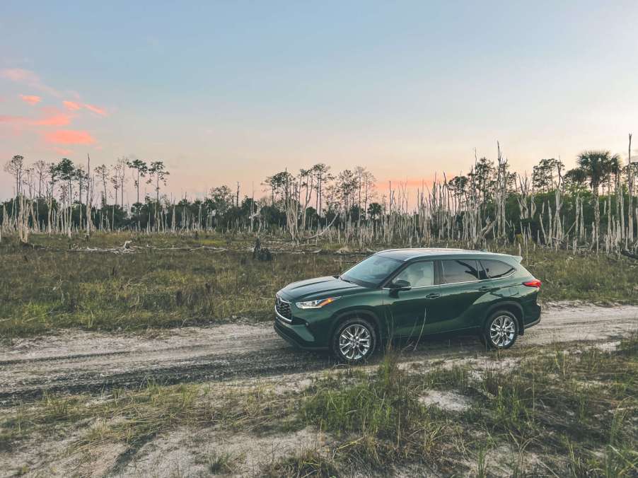 A green 2023 Toyota Highlander at sunset