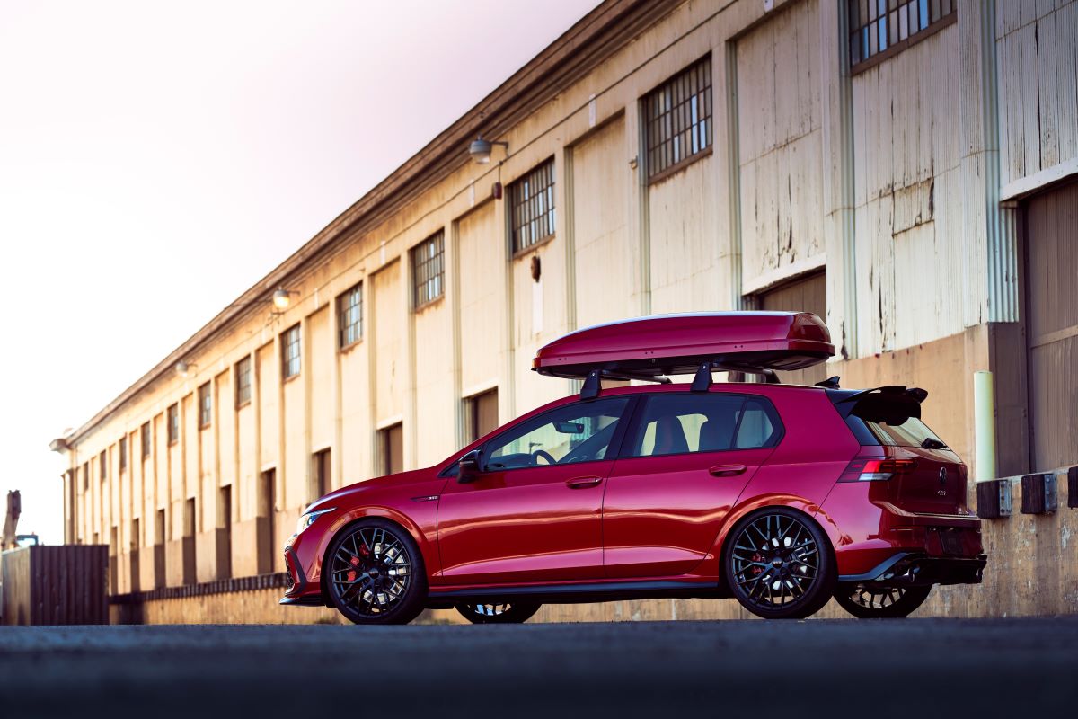 A red 2023 Volkswagen Golf GTI sport hatchback 'hot hatch' model with roof cargo carrier