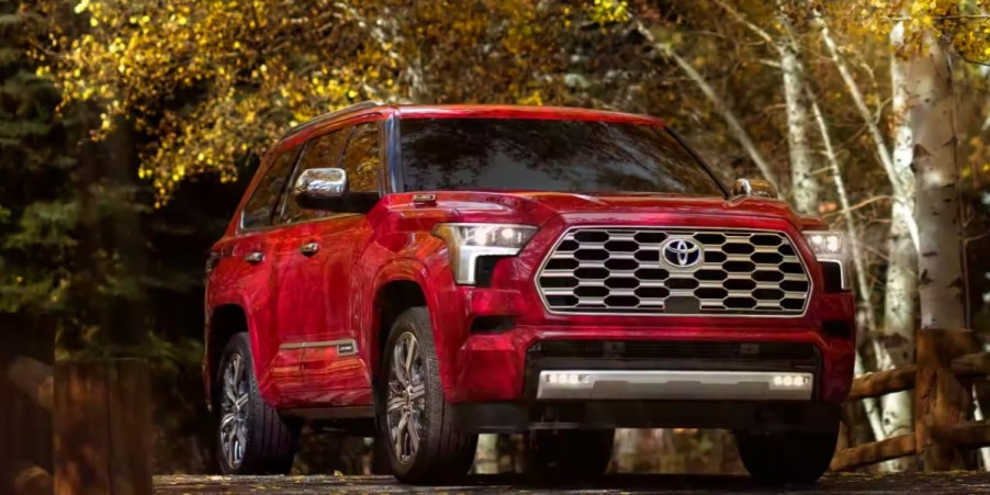 A red 2023 Toyota Sequoia full-size SUV is parked.