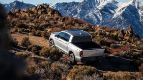 A 2023 Honda Ridgeline drives up a hill.