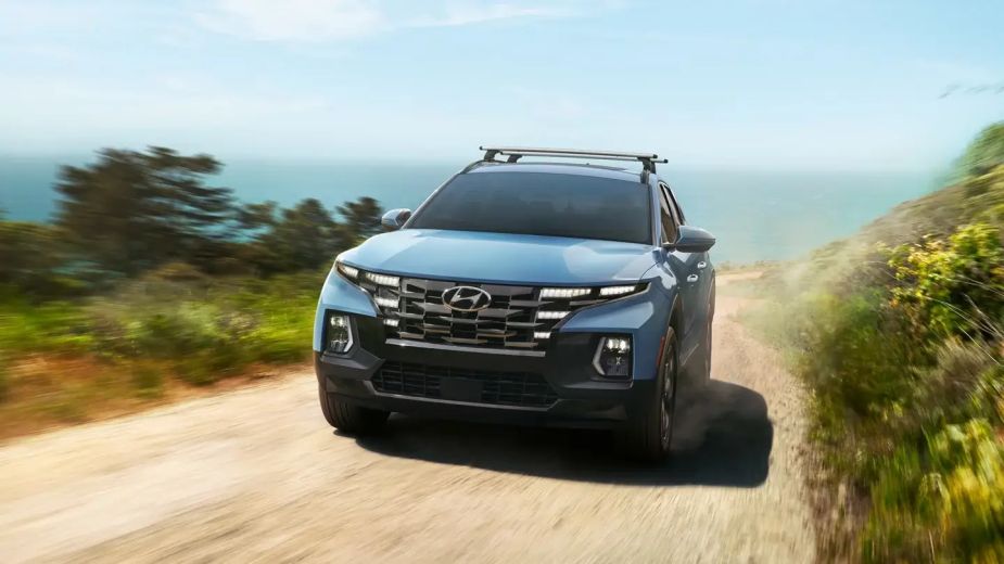 Hyundai's small truck, the 2023 Santa Cruz drives on a dirt road.