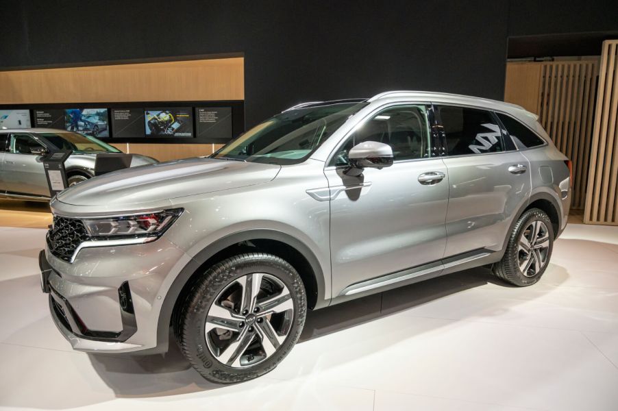 Silver 2023 Kia Sorento SUV on display at a motor show.