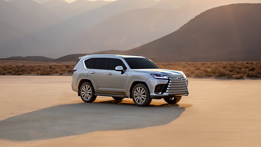 The 2023 Lexus RX sits in golden light with mountains in the background.