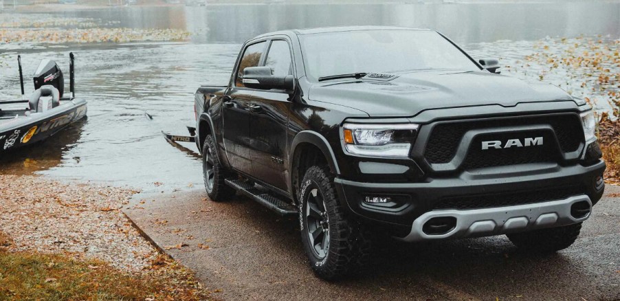 A 2023 Ram 1500 crew cab tows a boat out of water.