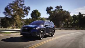 A new 2023 Subaru Ascent drives down a highway.