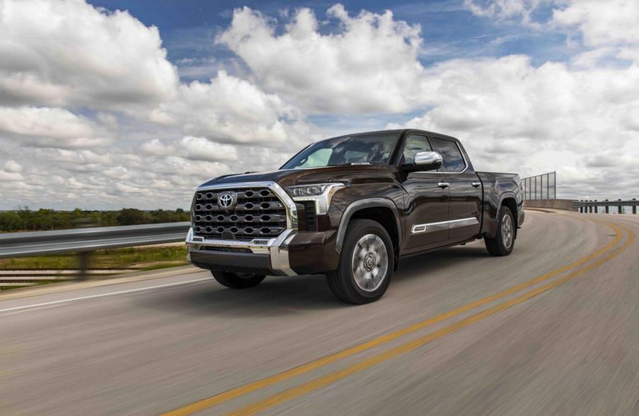 A brown 2023 Toyota Tundra pickup truck driving down the highway.