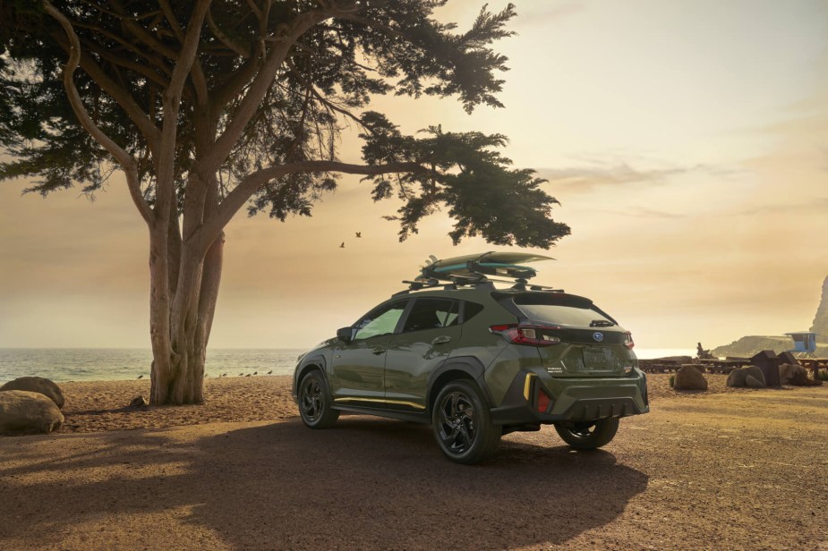 Rear view of green 2024 Subaru Crosstrek at sunset. 