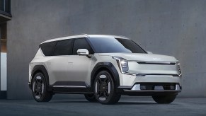 A white 2024 Kia EV9 midsize electric SUV is parked.