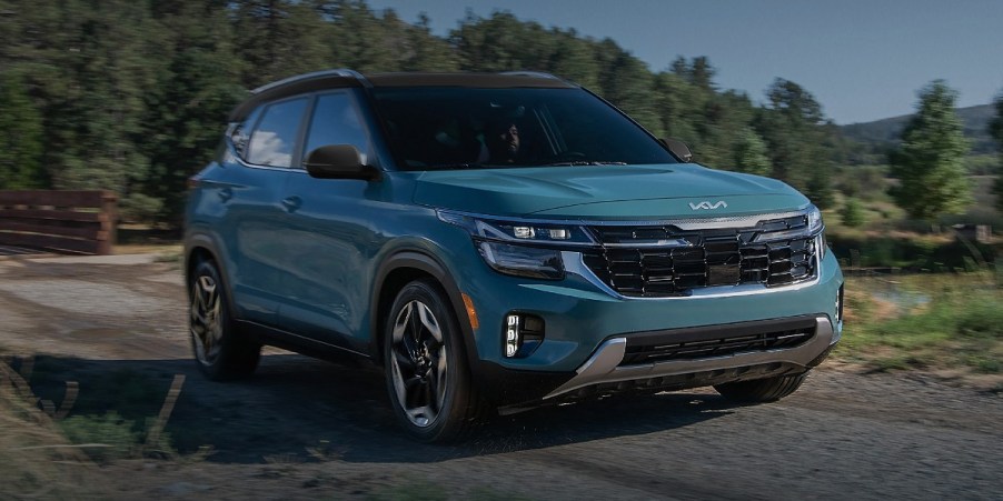 A blue 2024 Kia Seltos subcompact SUV is parked.