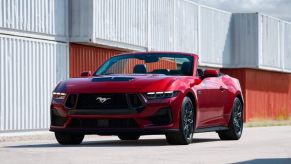 A fully loaded 2024 Ford Mustang GT Premium Convertible shows off its fascia and top in a harbor.