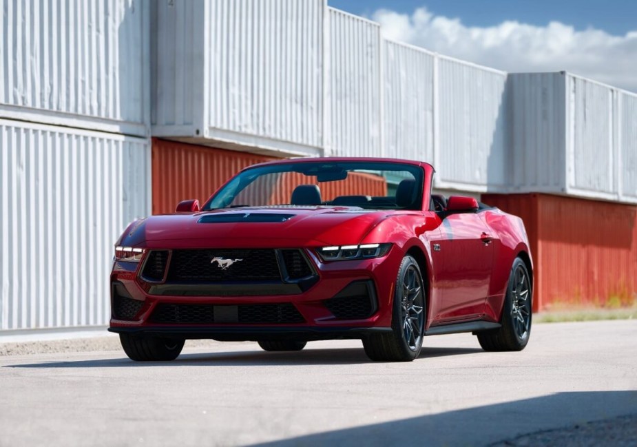 A fully loaded 2024 Ford Mustang GT Premium Convertible shows off its fascia and top in a harbor. 