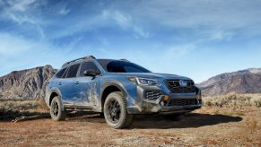 A 2024 Subaru Outback Wilderness drives off-road in the desert.