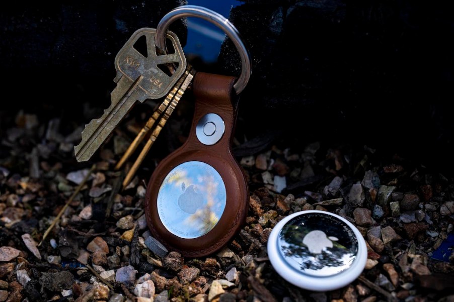 Apple AirTags next to a keychain.