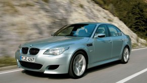 A 2010 BMW M5 luxury performance car shows off its silver paintwork.